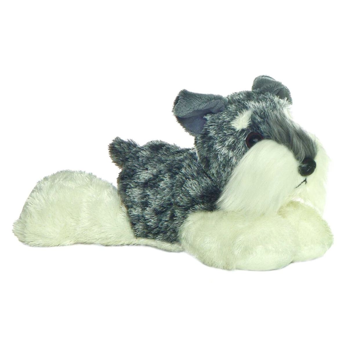 Side view of the Aurora Mini Flopsie Stein the Schnauzer 8-inch plush resting on its belly, featuring grey salt-and-pepper fur and a white beard.
