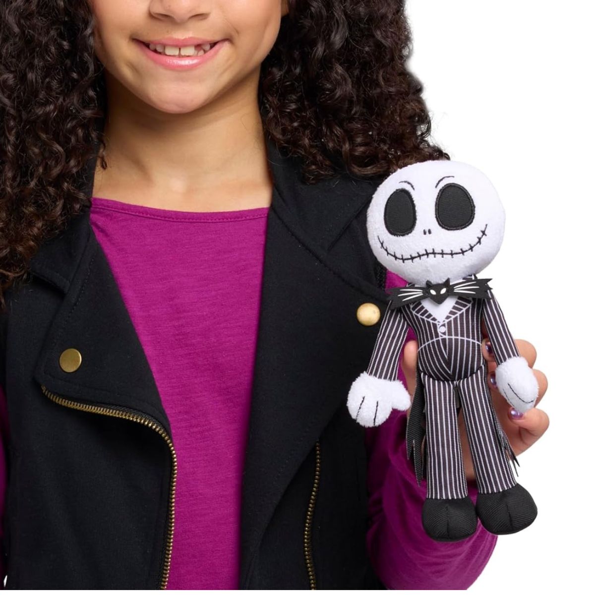 A young child holding the 8.5-inch Jack Skellington plush, showing the scale of the stuffed toy.