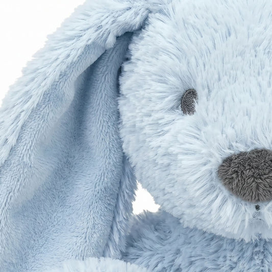 Close-up shot of the Happy Horse Rabbit Richie plush showing its soft light blue texture, long floppy ears, and dark grey fuzzy nose.