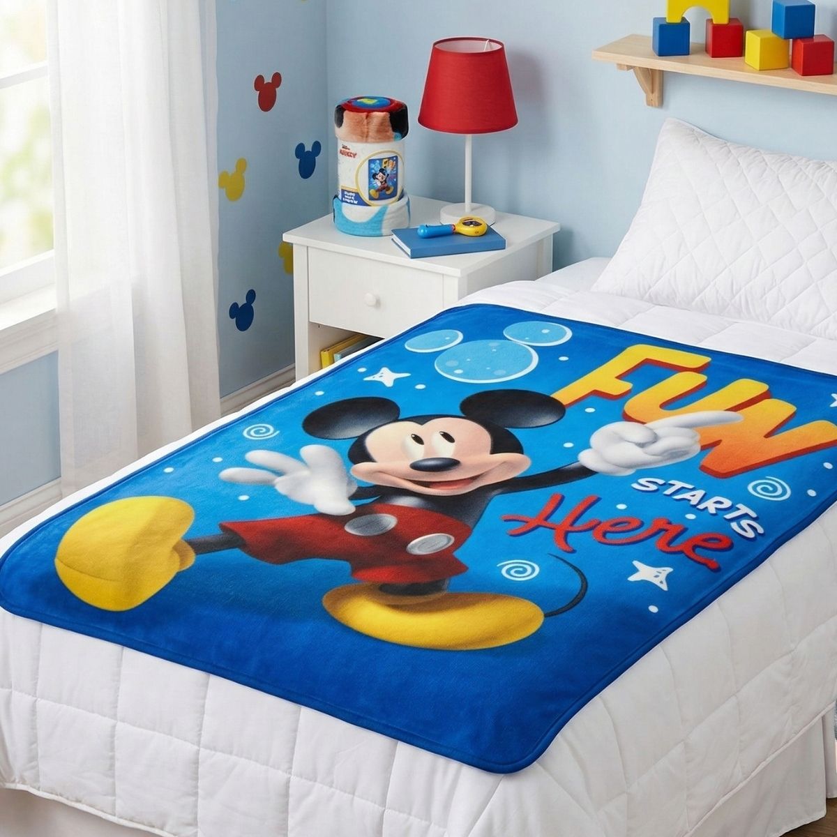 The Mickey Mouse throw blanket neatly folded and packaged with a branded Disney cardboard wrap.
