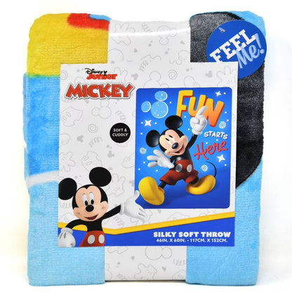 Lifestyle bedroom shot showing the Mickey Mouse 'Fun Starts Here' blanket draped beautifully over a child's bed.