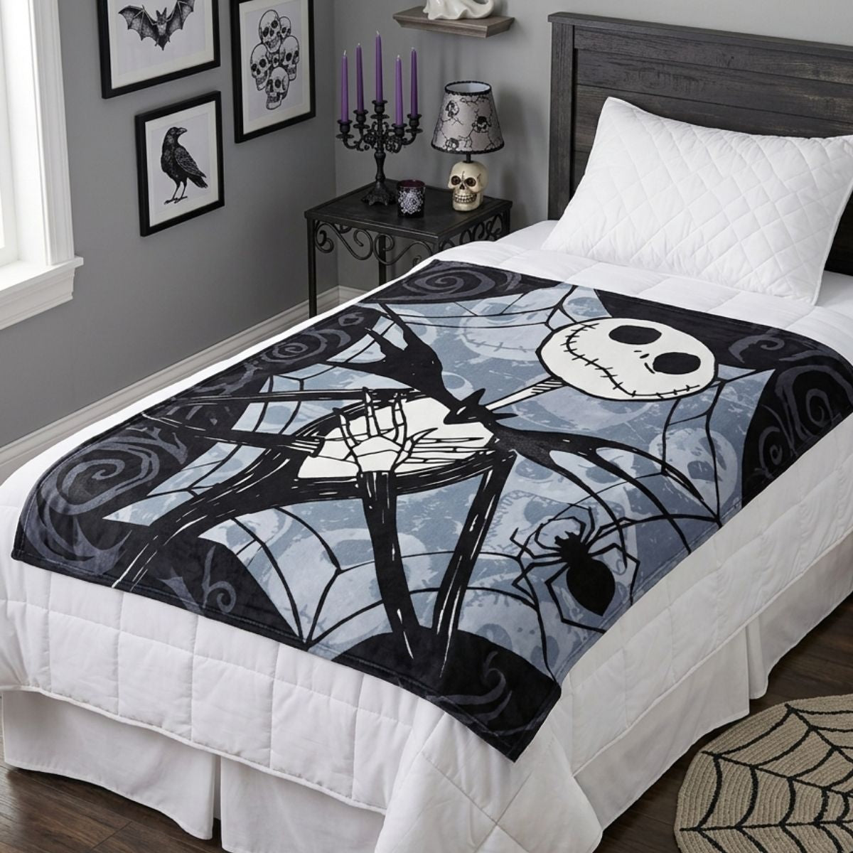 Lifestyle bedroom shot showing the Nightmare Before Christmas blanket draped beautifully over a bed with spooky decor.