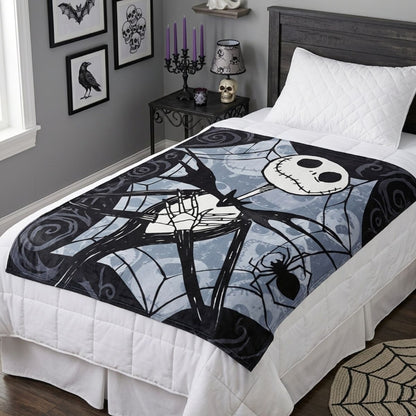 Lifestyle bedroom shot showing the Nightmare Before Christmas blanket draped beautifully over a bed with spooky decor.