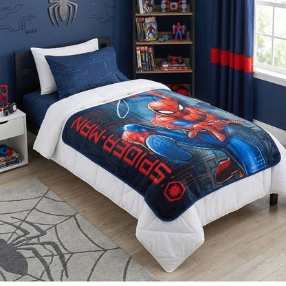 Lifestyle bedroom shot showing the Spider-Man action blanket draped over a bed in a superhero-themed room.