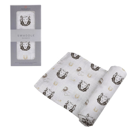 Newcastle Classics Hear Me Roar Lion bamboo swaddle blanket partially unrolled next to its grey retail packaging.