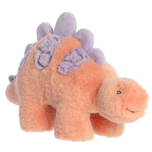 Angled side view of the 12-inch Aurora Softiesaurus Sammi Stegosaurus plush featuring shaggy peach fur and lavender purple plates.