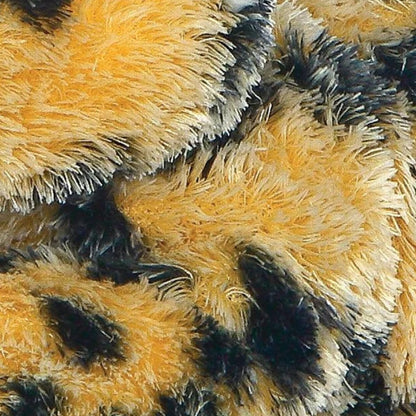 Detailed close-up of the plush fabric showing the soft golden-orange fur and black spot patterns.