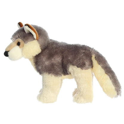 Side profile view of the cuddly Wily Wolf stuffed animal standing up, showing its bushy tail.