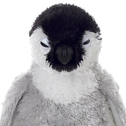 Close-up view of the soft baby penguin plush highlighting its black beak, white chest, and peaceful closed eyes.