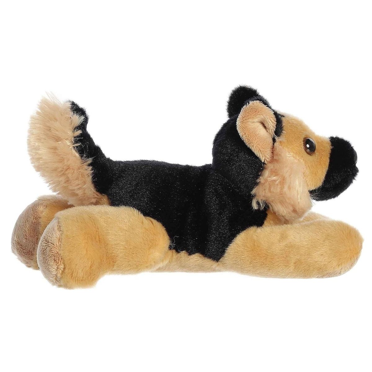 Side profile view of the cuddly Shep dog stuffed animal resting comfortably on its tummy.