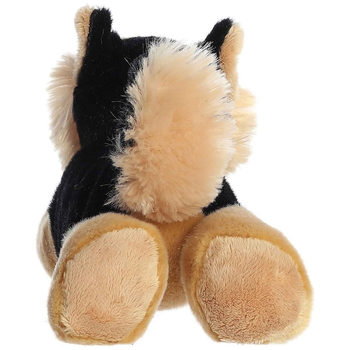 Direct back view of the dog plush highlighting its curled tail and tan hind legs.