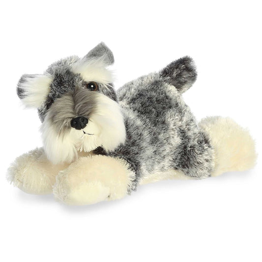 Angled side view of the Aurora Flopsie Ludwig the Schnauzer 12-inch plush resting on its belly, featuring salt-and-pepper fur and a white beard.