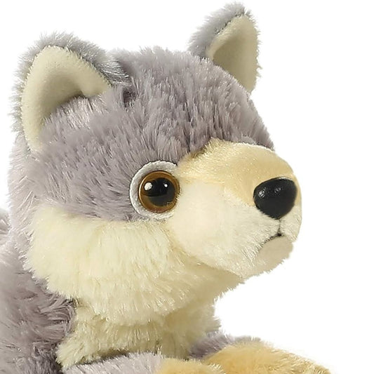 Close-up view of the wolf's face highlighting its sweet black nose, amber eyes, and soft cream muzzle.