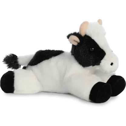 Angled side view of the Aurora Mini Flopsie Mini Moo Cow 8-inch plush resting on its belly, featuring a black-and-white spotted coat and black hooves.