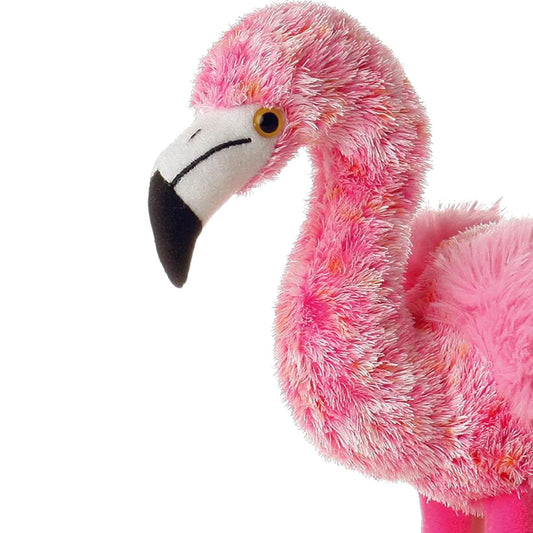 Close-up profile of the fluffy pink plush flamingo's head and neck, highlighting its black and white beak.