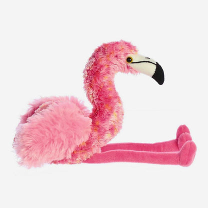 Side profile view of the Aurora Mini Flopsie Flavia the Flamingo plush resting in a seated position.