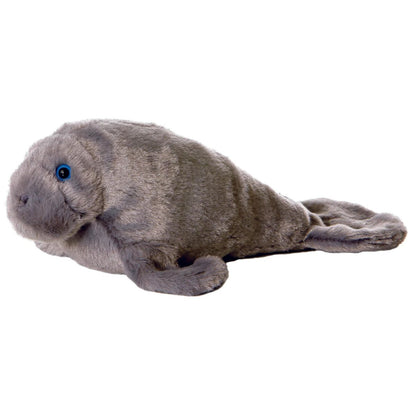 Side view of the Aurora Mini Flopsie Manny the Manatee 8-inch plush resting on its belly, featuring textured grey fur and blue eyes.
