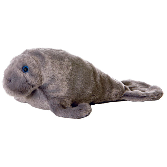 Side view of the Aurora Mini Flopsie Manny the Manatee 8-inch plush resting on its belly, featuring textured grey fur and blue eyes.