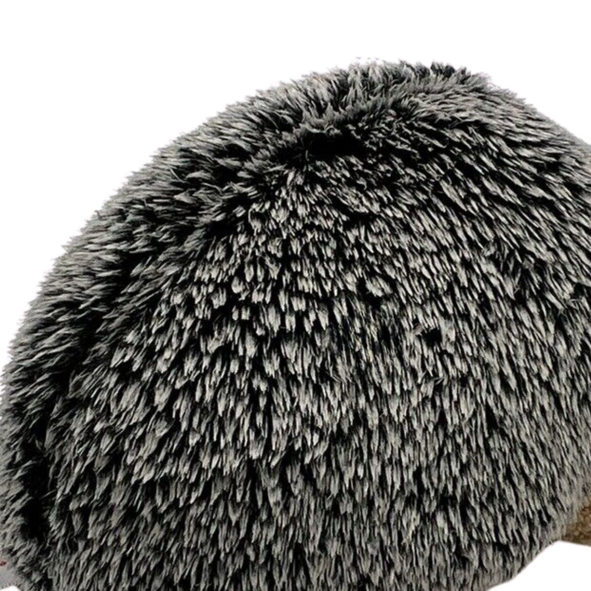 Close-up view of the hedgehog's salt-and-pepper plush fur, highlighting the soft textured "quill" fibers.