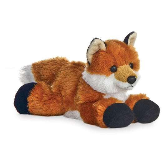 Angled view of the Aurora Mini Flopsie 8-inch Foxxie the Fox plush resting on its belly, showing its reddish-orange fur and black paws.