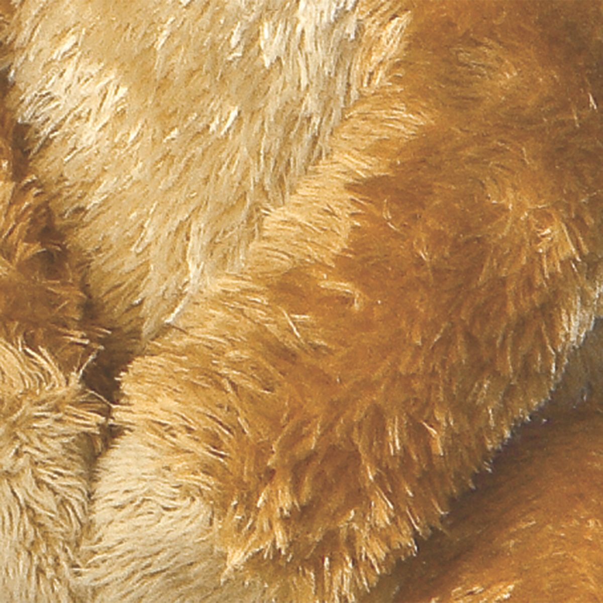 Close-up view highlighting the ultra-soft golden-brown plush fur and folded paws of the Mini Flopsie Meerkat toy.