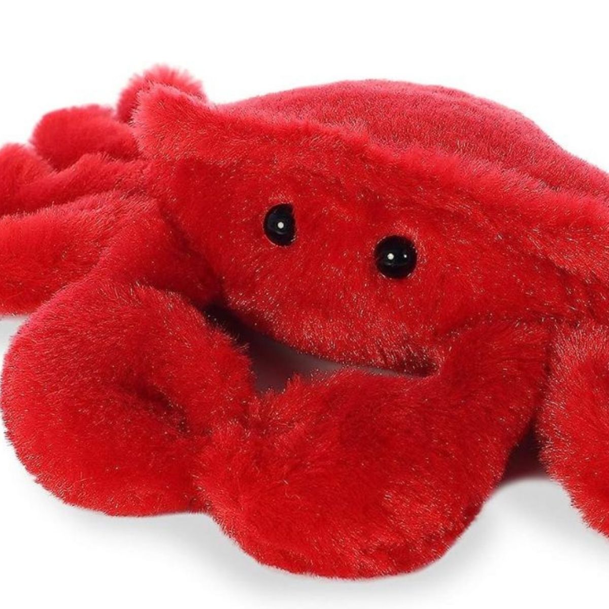 Close-up view of the soft red crab plush highlighting its dark eyes and fuzzy texture.