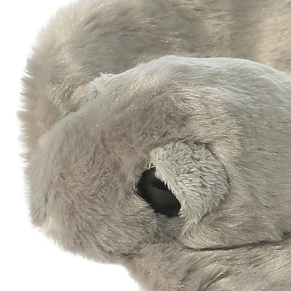 Close-up view of the stingray stuffed animal's head, highlighting its large dark eye and textured grey fur.