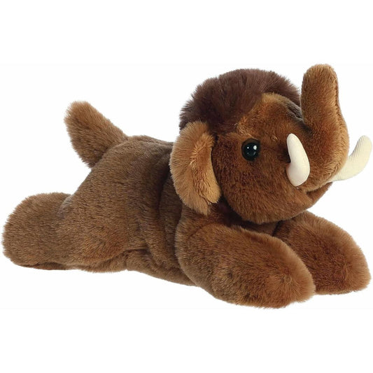 Angled front view of the Aurora Mini Flopsie Wynn Woolly Mammoth 8-inch stuffed animal resting on its belly, featuring brown fur, a raised trunk, and soft white tusks.