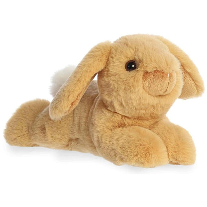 Angled view of the Aurora Flopsie 8-inch Biscuit Tan Lop Bunny plush laying down, showing its soft light brown fur and long floppy ears.