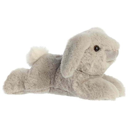 Side profile view of the Flopsie Lop Bunny plush highlighting its perfectly squishy body, relaxed lounging pose, and fluffy white tail.