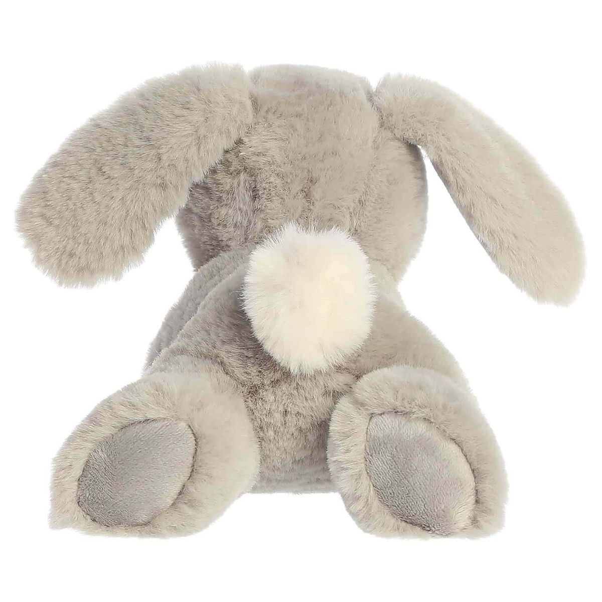 Back view of the Aurora Flopsie bunny plush toy showing its soft grey back, floppy ears resting down, grey foot pads, and a bright white cotton tail.