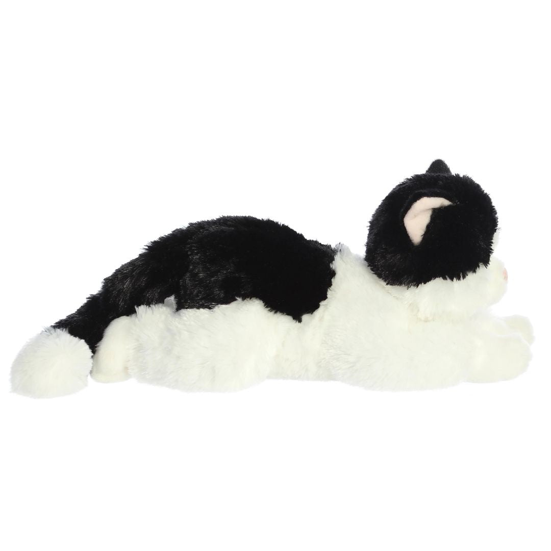 Side profile view of the cuddly Oreo cat stuffed animal resting comfortably on her tummy.