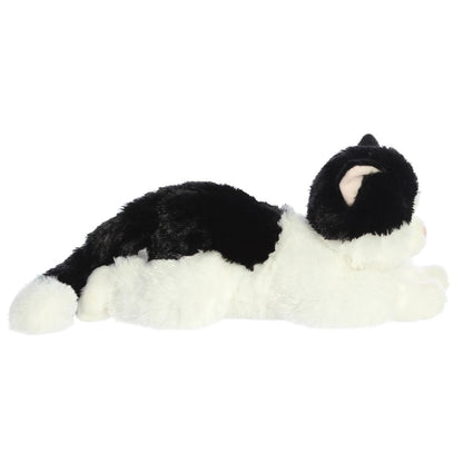 Side profile view of the cuddly Oreo cat stuffed animal resting comfortably on her tummy.