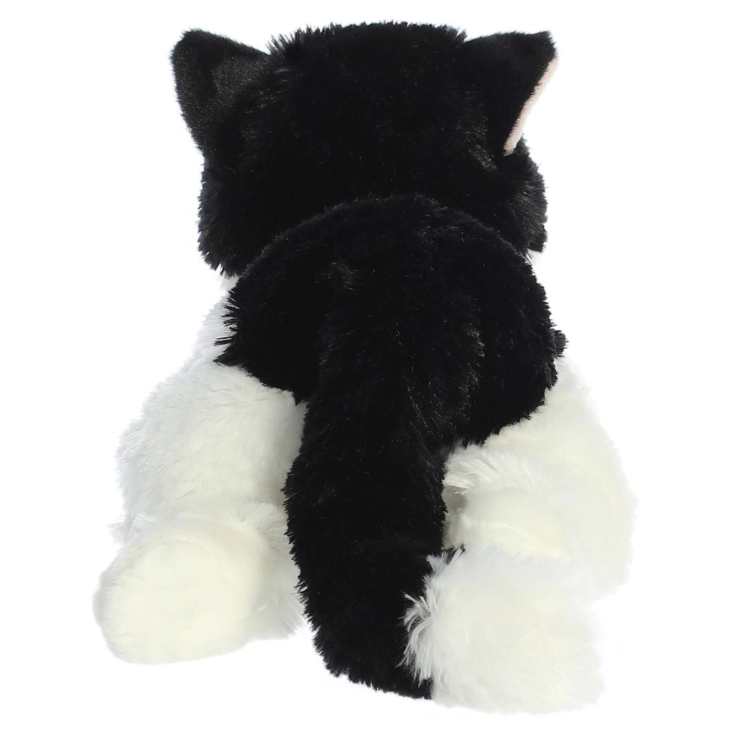 Direct back view of the tuxedo cat plush highlighting her black tail with a white tip and white hind paws.