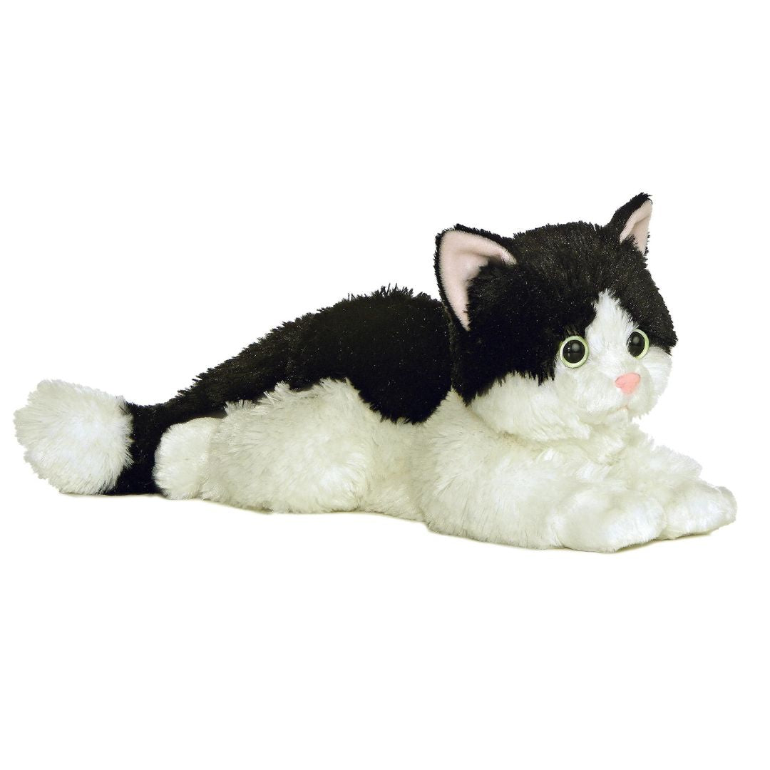 Angled front view of the 12-inch Aurora Flopsie Oreo Cat stuffed animal lying down, showing her black and white tuxedo fur.