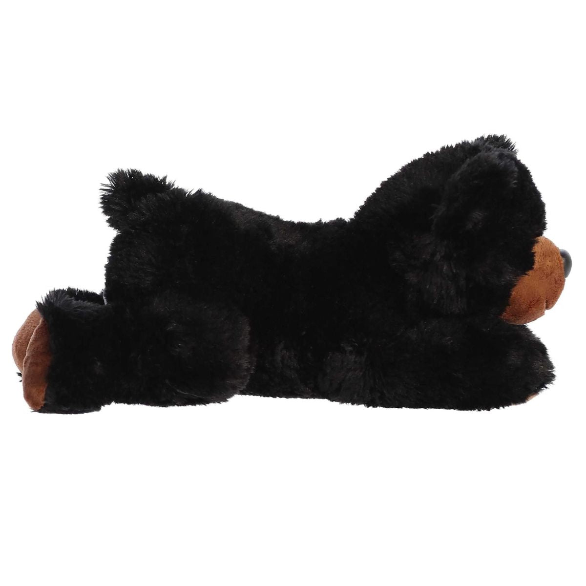 Side profile view of the black bear plush showing its lounging posture and short black tail.