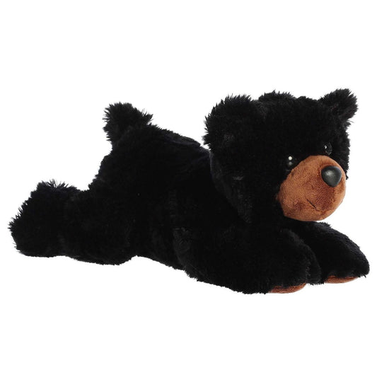 Angled front view of the Aurora Flopsie Sullivan Black Bear 12-inch plush resting on its belly, featuring soft black fur and a brown snout.