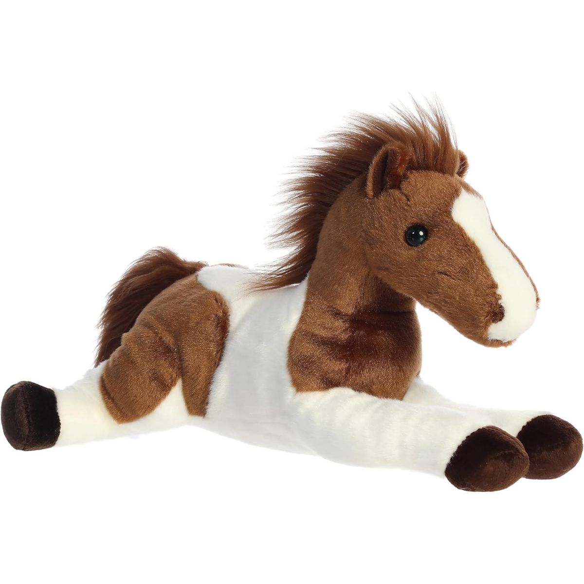 Angled front view of the 12-inch Aurora Flopsie Tola the Pinto Horse stuffed animal lying down, showing its brown and white patched coat.