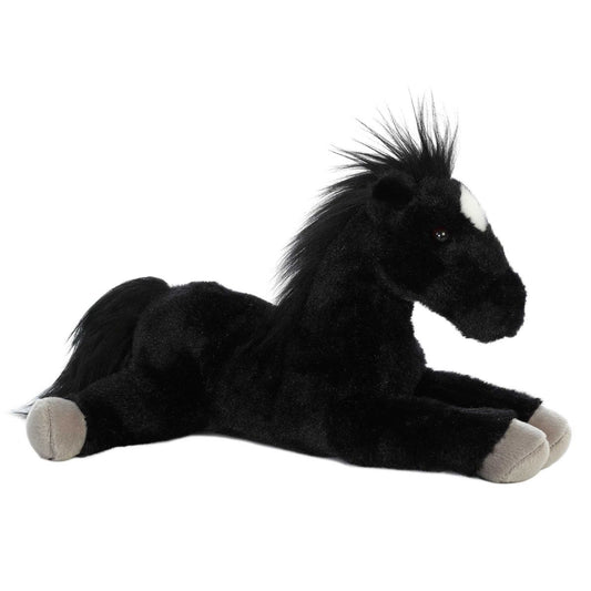 Angled side view of the Aurora Flopsie Blackjack the Black Stallion 12-inch plush resting on its belly, featuring solid black fur, a fluffy mane, and a white star marking.