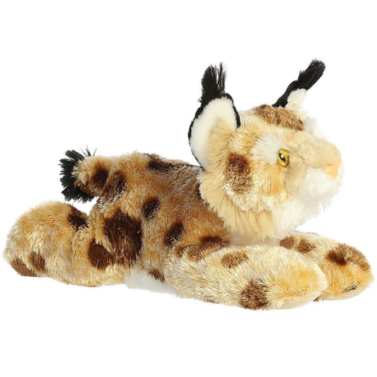 Angled front view of the Aurora Flopsie Bobby the Bobcat 12-inch plush resting on its belly, featuring tan fur with dark spots and black ear tufts.