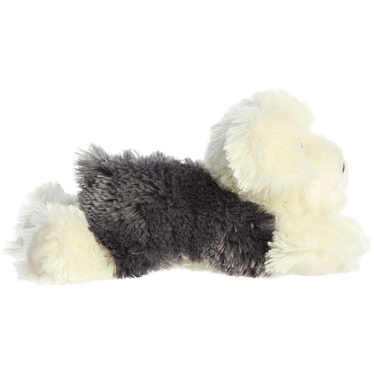 Side profile view of the shaggy grey and cream Sheepdog plush showing its lounging posture.