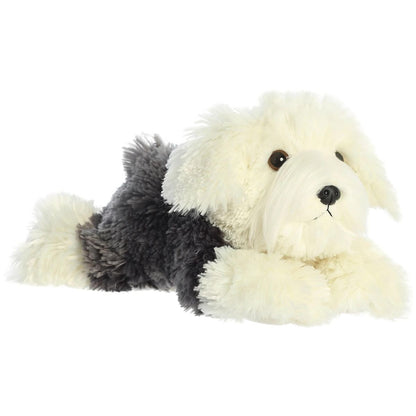 Angled side view of the Aurora Flopsie Edwin the Sheepdog 12-inch plush resting on its belly, featuring shaggy grey and cream fur.