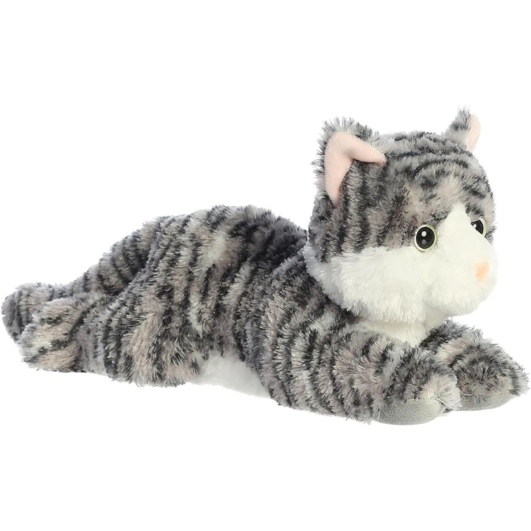 Angled front view of the 12-inch Aurora Flopsie Lily Silver Tabby Cat stuffed animal lying down, showing her grey striped fur and white paws.