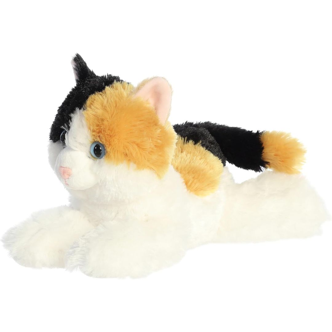 Slightly angled side-front view of the soft calico cat plush resting on her tummy.