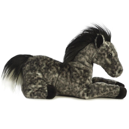 Side profile view of the grey horse stuffed animal highlighting its lounging posture, soft black hooves, and fluffy black tail.