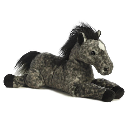 Angled side view of the Aurora Flopsie Jack the Grey Horse 12-inch plush resting on its belly, featuring mottled grey fur, a black mane, and a white star marking.