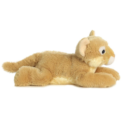 Side profile view of the tan cougar plush showing its lounging posture, white underbelly, and long tail.