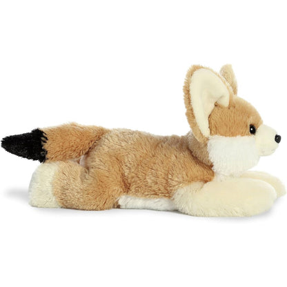 Side profile view of the fennec fox stuffed animal highlighting its lounging posture, white underbelly, and black-tipped tail.