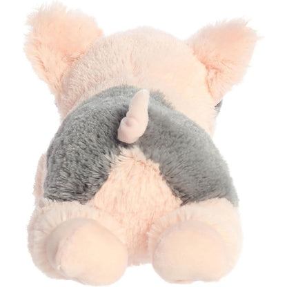 Rear view of the Tidbit Pig plush showing its dark grey back patch, pastel pink body, and signature curly tail.