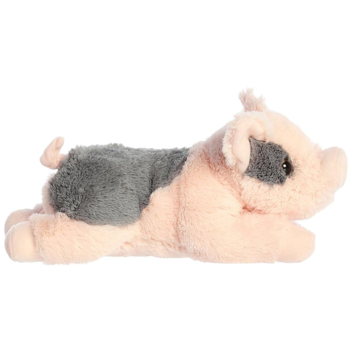 Side profile view of the pink and grey pig plush showing its lounging posture, floppy ears, and cute curly tail.